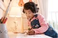 Drawing is her favourite activity. Shot of a little girl drawing on a piece of paper at home. Royalty Free Stock Photo