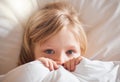 I dont feel good at all. Shot of a little girl feeling ill in bed at home and covering with a blanket. Royalty Free Stock Photo