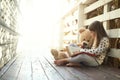 Which story should we ready next teddy. Shot of a little girl reading a book with her teddy bear beside her. Royalty Free Stock Photo