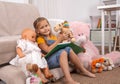 A little girl spends time at home playing with toys