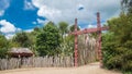 Exotic native Maori garden display with carved red gate and hut, Royalty Free Stock Photo