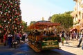 A shot of Main Street in Disneyland, California, with a horse drawn carriage in the foreground and a touring car