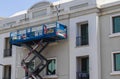 Shot of a maintenance workers working at heights, repairing facade of the building. Industrial
