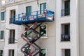 Shot of a maintenance workers working at heights, repairing facade of the building. Industrial