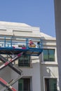 Shot of a maintenance workers working at heights, repairing facade of the building. Industrial