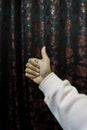 A shot of a male`s hand. Hand showing gesture of the thumbs up.