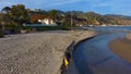 Man with a backpack walking along the beach with blue ocean water Royalty Free Stock Photo