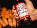 Shot of a man holding a bottle of Budweiser beer.