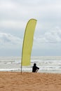 Flag and person on beach Royalty Free Stock Photo