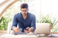 Shot of man using smartphone and bank card while banking online Royalty Free Stock Photo