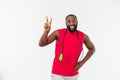 Shot of masculine man skipping rope. Muscular young man exercising with jumping rope against grey background