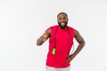 Shot of masculine man skipping rope. Muscular young man exercising with jumping rope against grey background