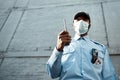 Proactive guarding for your propertys protection. Shot of a masked young security guard using a two way radio while on Royalty Free Stock Photo