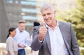 My team are on the right track. Shot of a mature businessman standing outside and showing a thumbs up while his Royalty Free Stock Photo