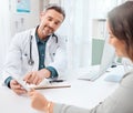 Its easier to explain like this. Shot of a mature doctor using a digital tablet during a consultation with a patient in Royalty Free Stock Photo