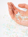 Shot of microplastics lay on human hand. Concept of water pollution and global warming. The idea of environmental damage. White Royalty Free Stock Photo