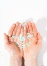 Shot of microplastics lay on human hand. The idea of environmental damage. Concept of water pollution and global warming. White Royalty Free Stock Photo