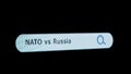 Shot of monitor screen. Pixel screen with animated search bar, keywords NATO vs Russia typed in, browser bar with Royalty Free Stock Photo