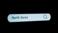 Shot of monitor screen. Pixel screen with animated search bar, keywords North Korea typed in, browser bar with