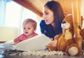 Fuelling his imagination with new tales. Shot of a mother reading a book with her little son at home. Royalty Free Stock Photo