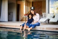 Bonding with my boy. Shot of a mother and son dipping their feet into the pool on the patio. Royalty Free Stock Photo