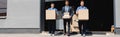 Shot of movers and businessman holding Royalty Free Stock Photo