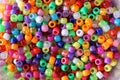 Shot of multi-colored plastic beads for handicrafts scattered on the table Royalty Free Stock Photo