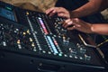 Shot of a multi-track sound mixer for live events with a man`s hands on the console pushing buttons Royalty Free Stock Photo