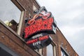 A shot of the neon sign outside of The Second Fiddle along Broadway street on a cloudy day in Nashville Tennessee