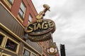 A shot of the neon sign outside of The Stage on Broadway along Broadway street on a cloudy day in Nashville Tennessee Royalty Free Stock Photo