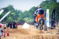 shot of off road dirt bike rider going over jump in on mud track and then speeding to fast stop in a hero xpulse offroad