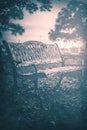 A creepy foggy bench in a graveyard.  This is suited well for horror projects. Royalty Free Stock Photo