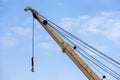 Shot of an old, rusty port crane preparing to lift cargo in ship on overcast sky background Royalty Free Stock Photo