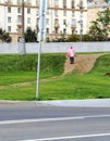 Shot of the old woman walking down the hill. People