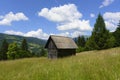 Old wooden house in mountains. Alone cabin in the mountain forest