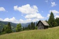 Old wooden house in mountains. Alone cabin in the mountain forest