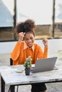 Shot of overjoyed African American woman getting mail, read good news on laptop computer