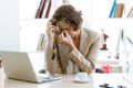 Overworked businesswoman suffering from headache in the office. Royalty Free Stock Photo