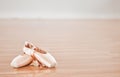 Sign up for ballet classes. Shot of a pair of ballet shoes in a dance studio.