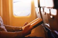 Reading is one way for your imagination to take flight. Shot of a passenger reading a book on an airplane. Royalty Free Stock Photo