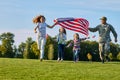 Shot of patriotic family running with flag. Royalty Free Stock Photo