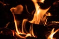 Shot of a piece of woods burning in the fire flames in the night - great for wallpapers Royalty Free Stock Photo