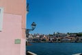 A shot of a pink building and street lamp overlooking the douro river in Porto, Portugal