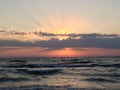 Shot of pink sunrise and scenic sscape, bright sun shining behind the clouds