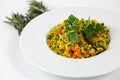 Shot of a a plate of Couscous with vegetables on a white table decorated with green plants