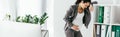 Shot of pregnant woman leaning on bookcase with folders in office Royalty Free Stock Photo