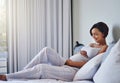 The big day is almost here. Shot of a pregnant young woman relaxing on the bed at home. Royalty Free Stock Photo