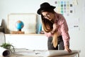 Pretty young architect woman working on a blueprints in the office. Royalty Free Stock Photo