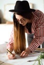 Pretty young architect woman working on a blueprints in the office. Royalty Free Stock Photo