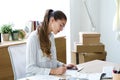 Pretty young businesswoman writing notes in her notebook in the office Royalty Free Stock Photo